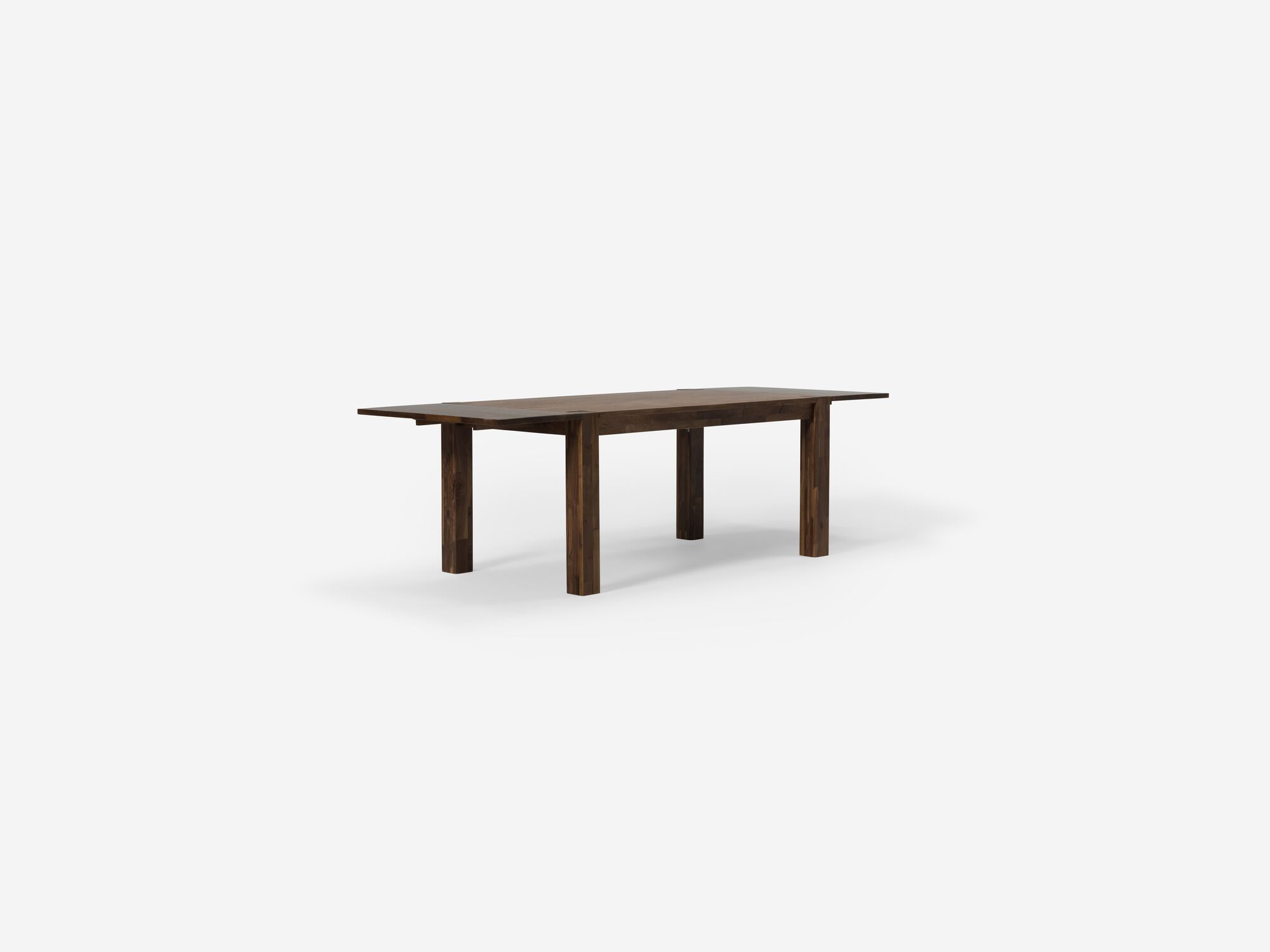 Angled view of the small walnut Harvest modern rustic dining table